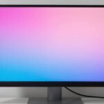 Professional monitor screen split to compare uncalibrated and calibrated display with LED screen calibration tool in foreground